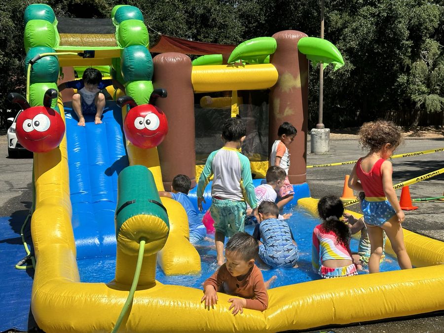 Children playing on a water slide at Butterflies Academy